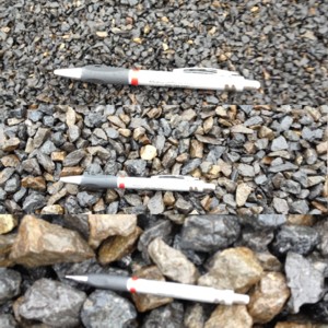 Photo of Black Crushed gravel. In photo is 1/8in, 1/2in, and 1 1/2in. It is a crushed black Basalt natural stone gravel. Decretive natural stone gravel sold by Rolleri Landscape Products.
