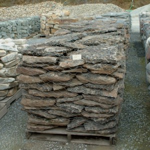 Photo of Cold Water Canyon Moss Rock. A flat waterwashed looking rock with lichen and moss on it. Use for Wall Cap Stone, Masonry Stone Wall veneer, Water feature and Ponds. Natural stone sold by Rolleri Landscape Products.